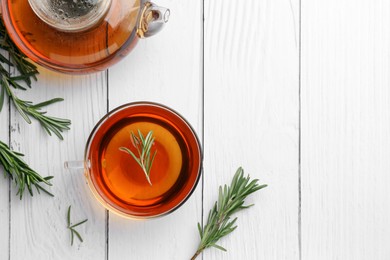 Photo of Aromatic herbal tea with rosemary on white wooden table, flat lay. Space for text