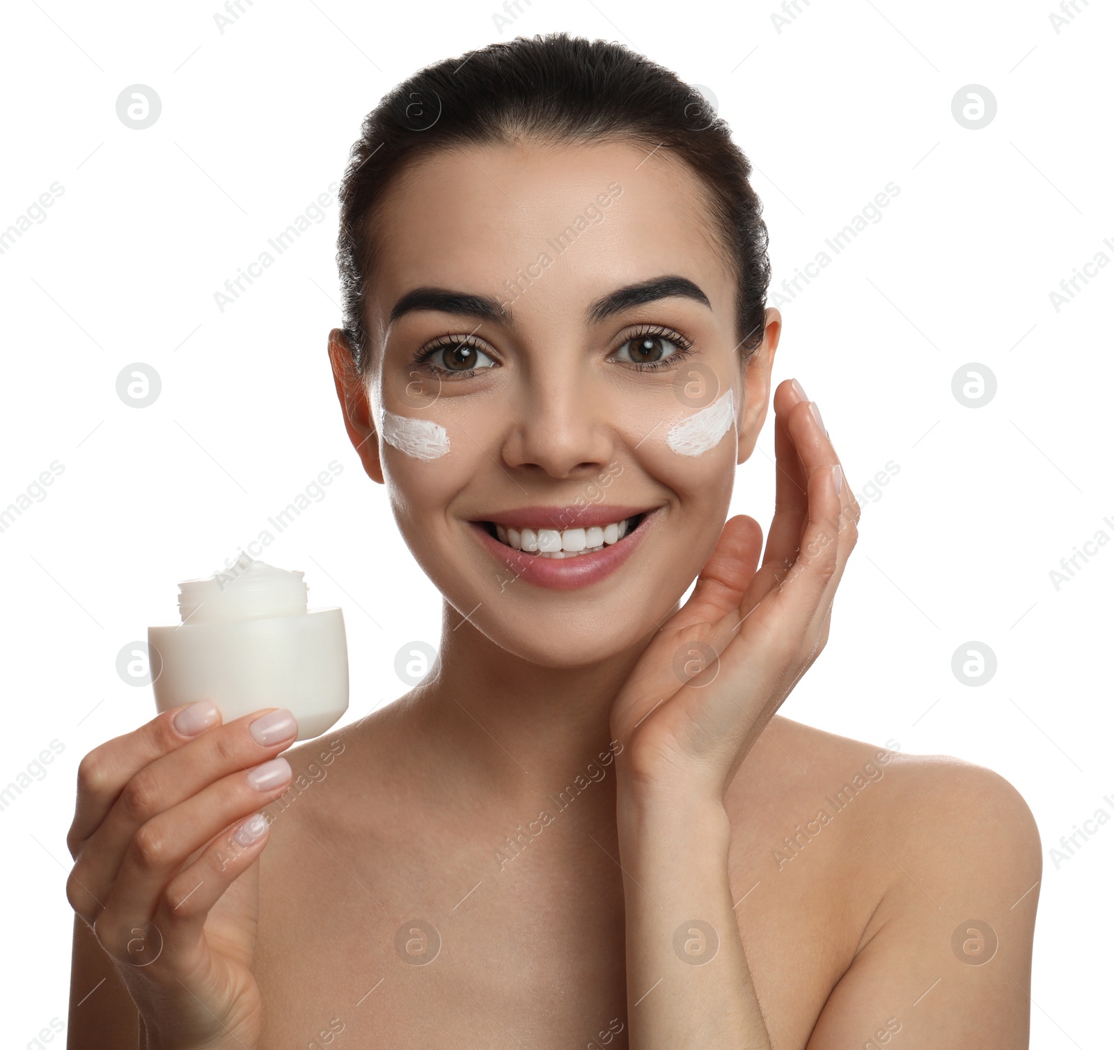 Photo of Young woman applying facial cream on white background