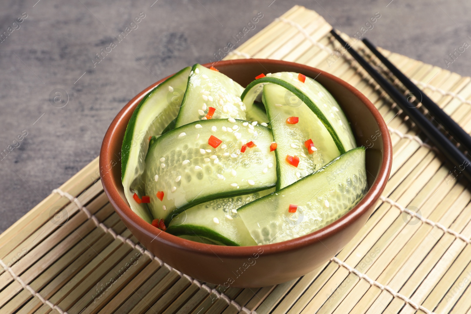 Photo of Dish with fresh cucumber salad served on table