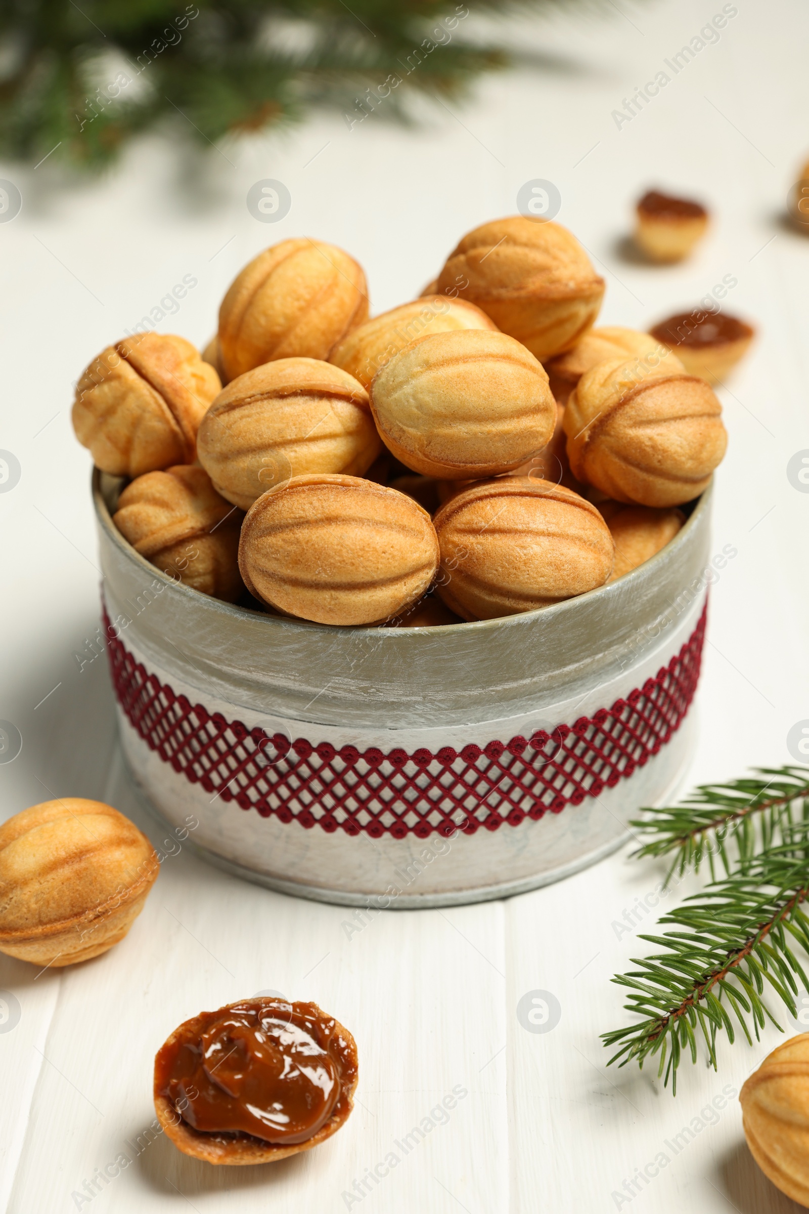 Photo of Homemade walnut shaped cookies with boiled condensed milk on white woden table