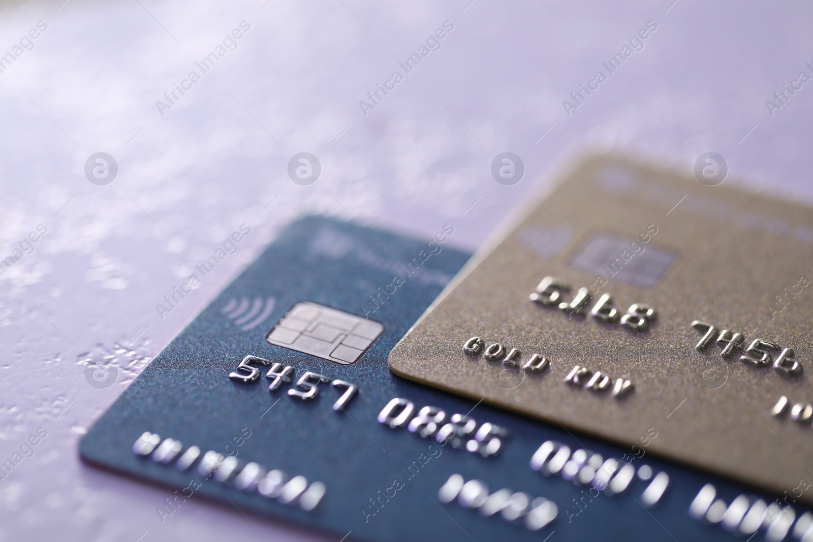 Photo of Plastic credit cards on table, closeup view. Color toned