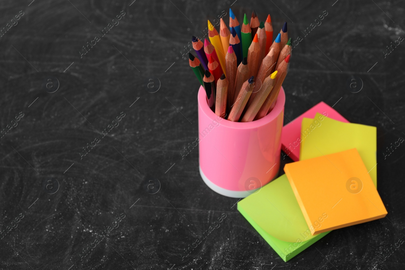 Photo of Different stationery on blackboard, space for text. Back to school