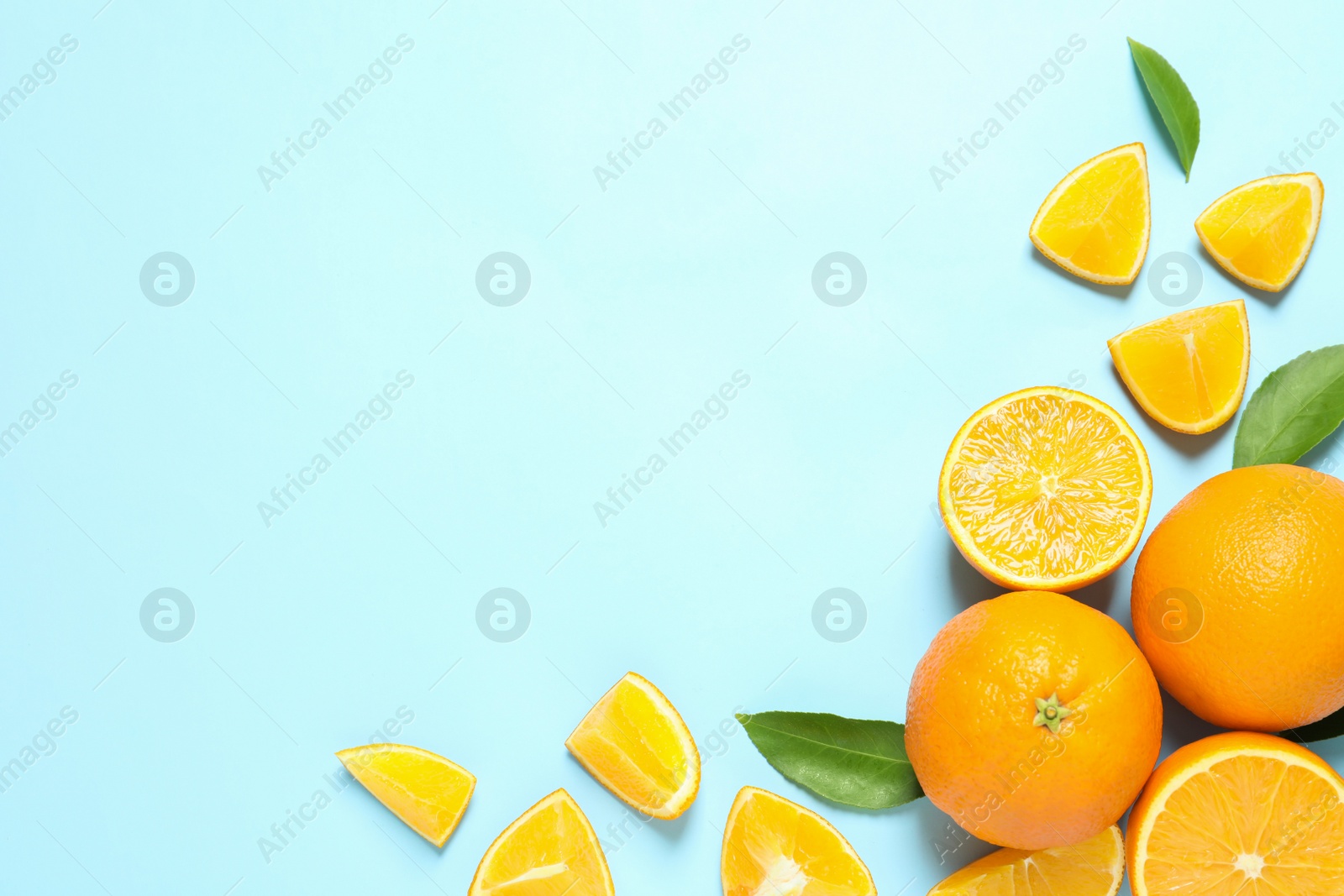 Photo of Flat lay composition with ripe oranges and space for text on color background