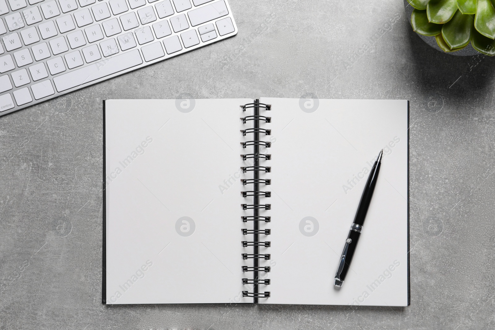 Photo of Flat lay composition with stylish notebook on grey table