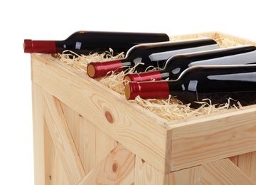 Photo of Wooden crate with bottles of wine isolated on white, closeup