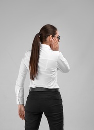 Photo of Female security guard in uniform on color background