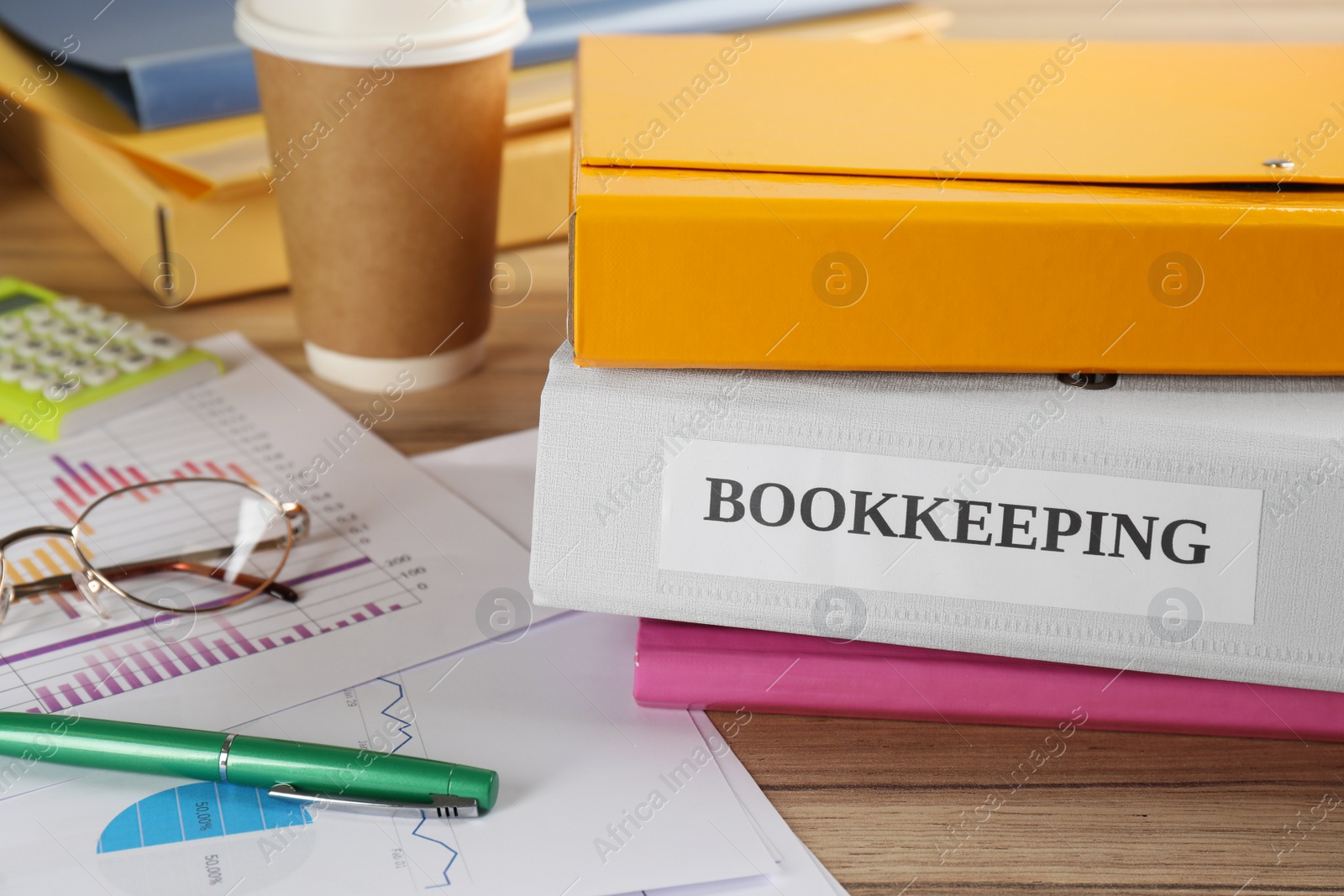 Photo of Folders and documents on desk in office, closeup. Bookkeeper's workplace