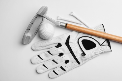 Photo of Set of golf equipment on white background, flat lay
