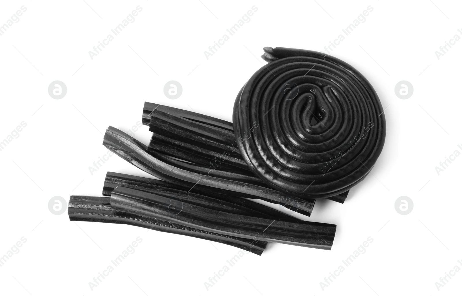 Photo of Tasty black liquorice candies on white background, top view