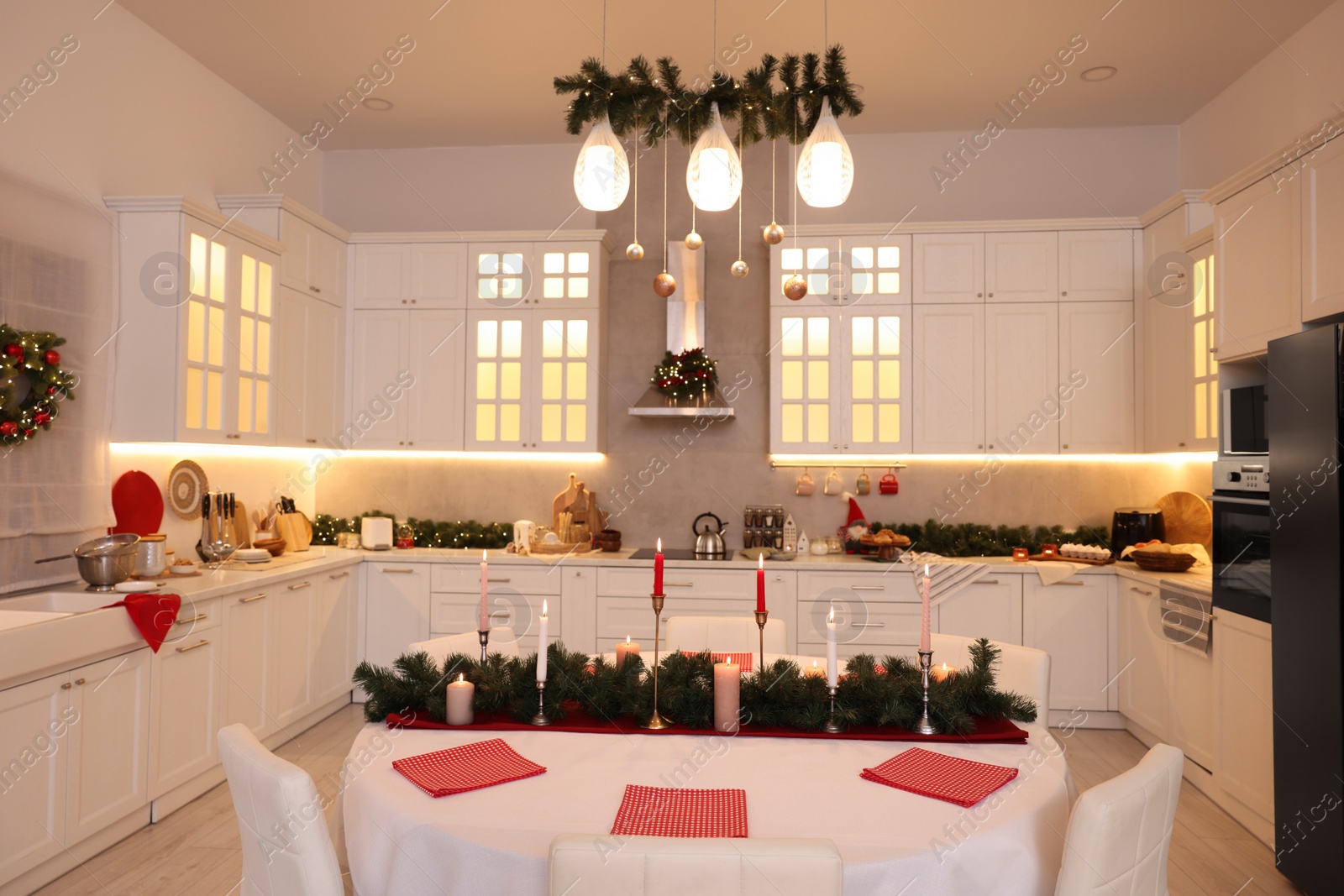 Photo of Cozy spacious kitchen decorated for Christmas. Interior design