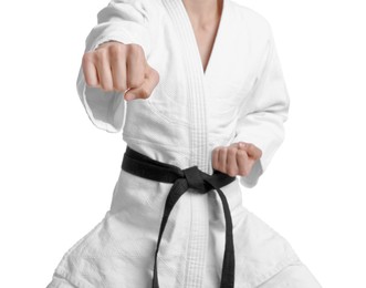 Photo of Martial arts master in keikogi with black belt against white background, focus on fist