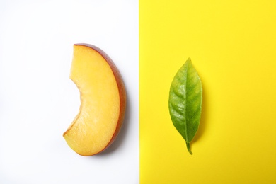 Photo of Flat lay composition with ripe peach and leaf on color background