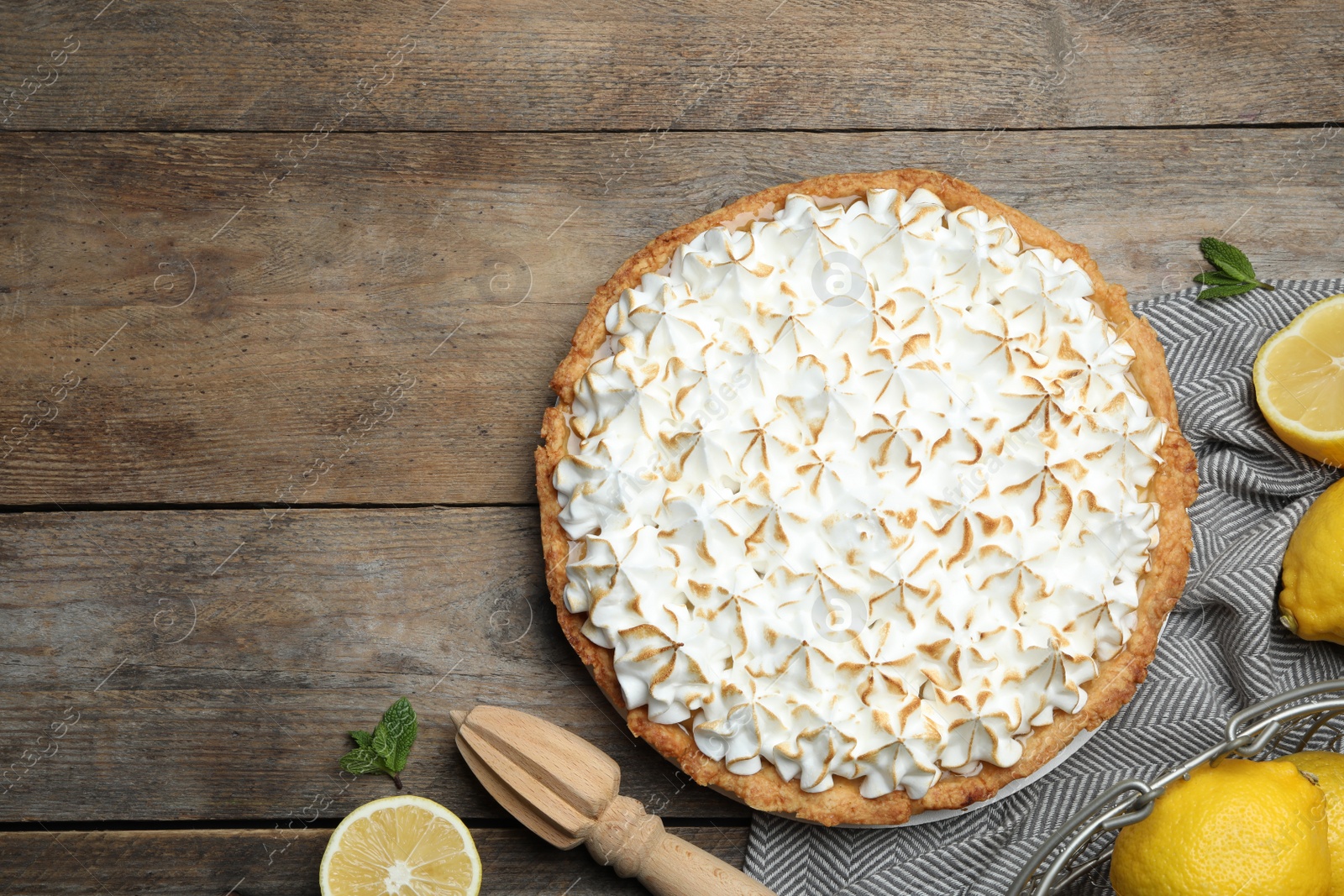 Photo of Flat lay composition with delicious lemon meringue pie on wooden table
