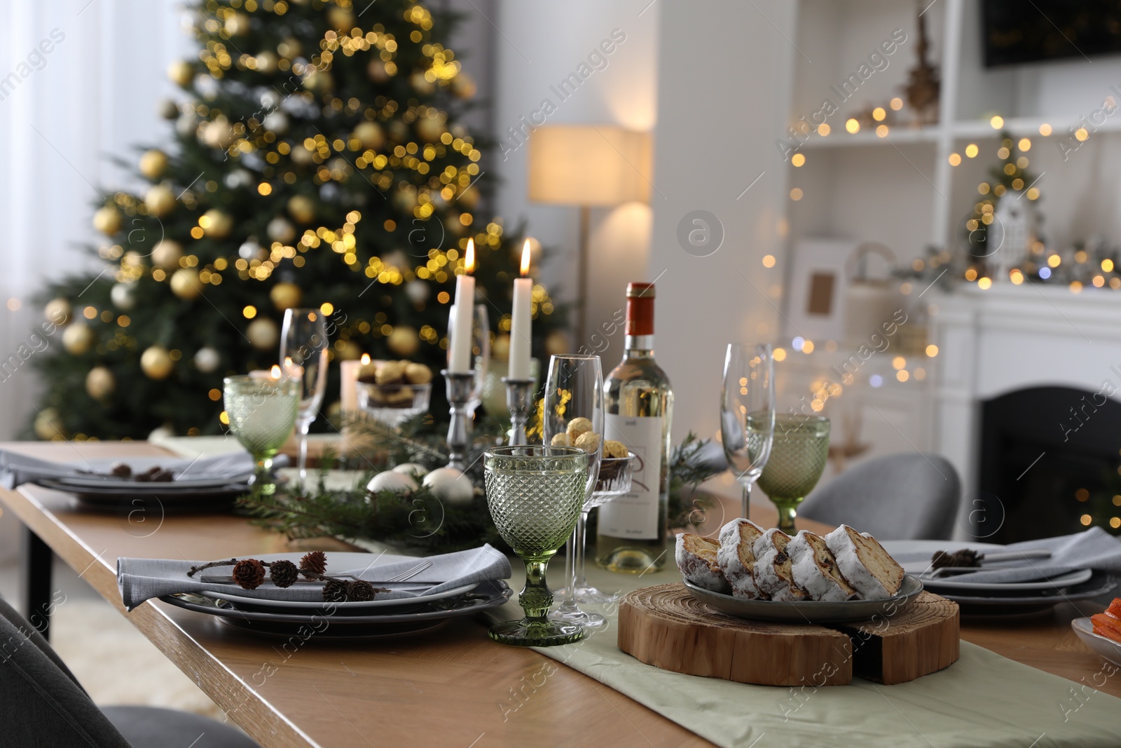 Photo of Christmas table setting with festive decor and dishware in living room