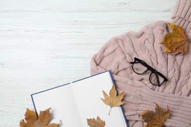 Photo of Flat lay composition with open notebook and autumn leaves on white wooden table. Space for text