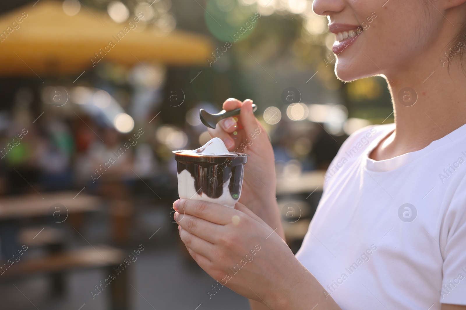 Photo of Lviv, Ukraine - September 26, 2023: Woman with McDonald's ice cream outdoors, closeup. Space for text