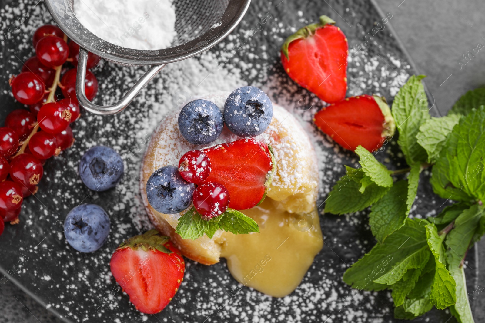 Photo of Tasty vanilla fondant with white chocolate and berries on table, flat lay