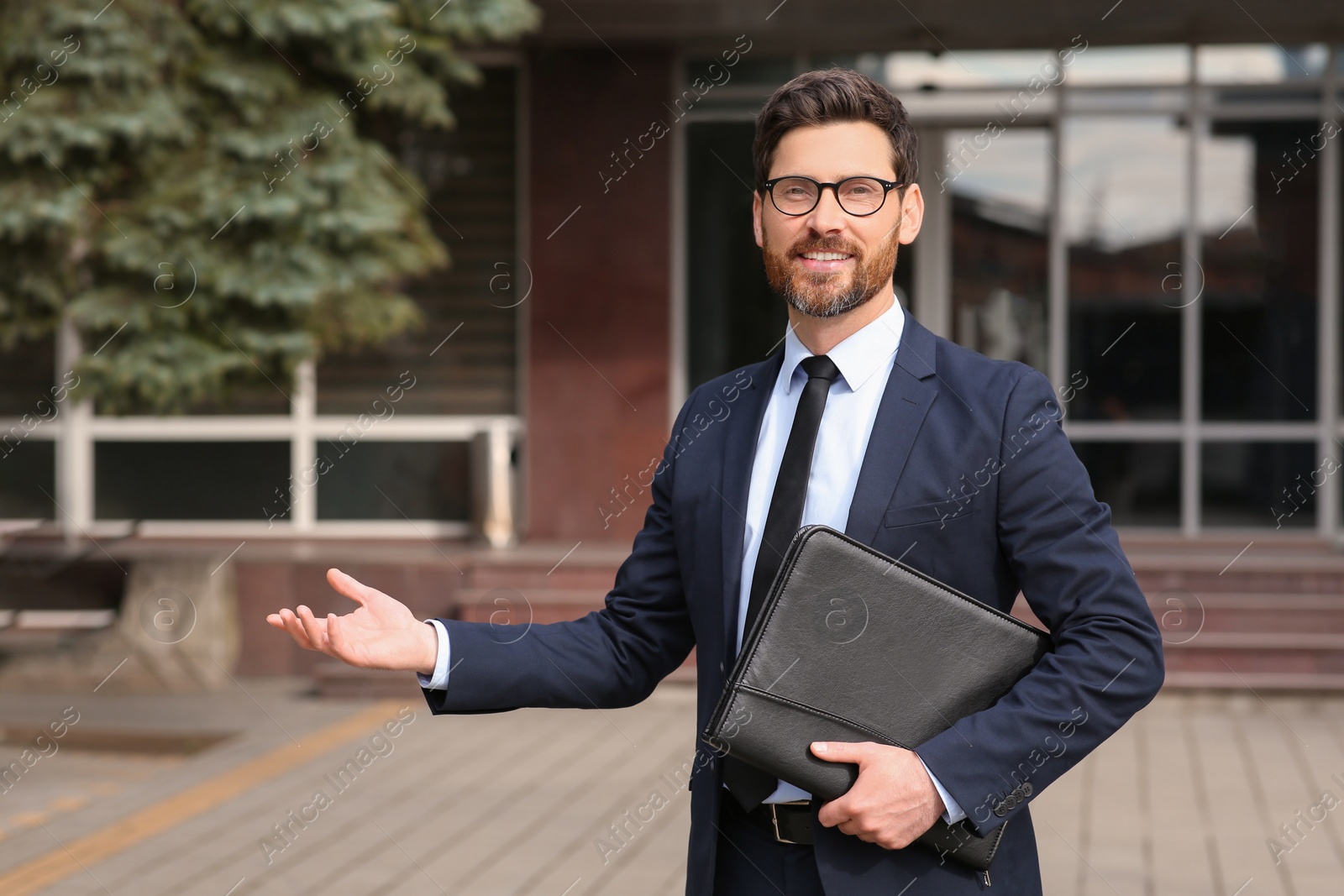 Photo of Handsome real estate agent with documents outdoors, space for text