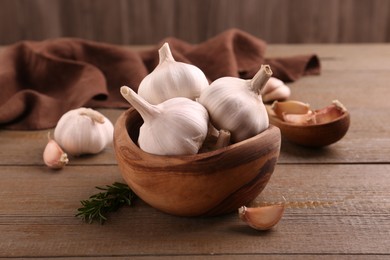 Photo of Fresh garlic on wooden table, closeup view