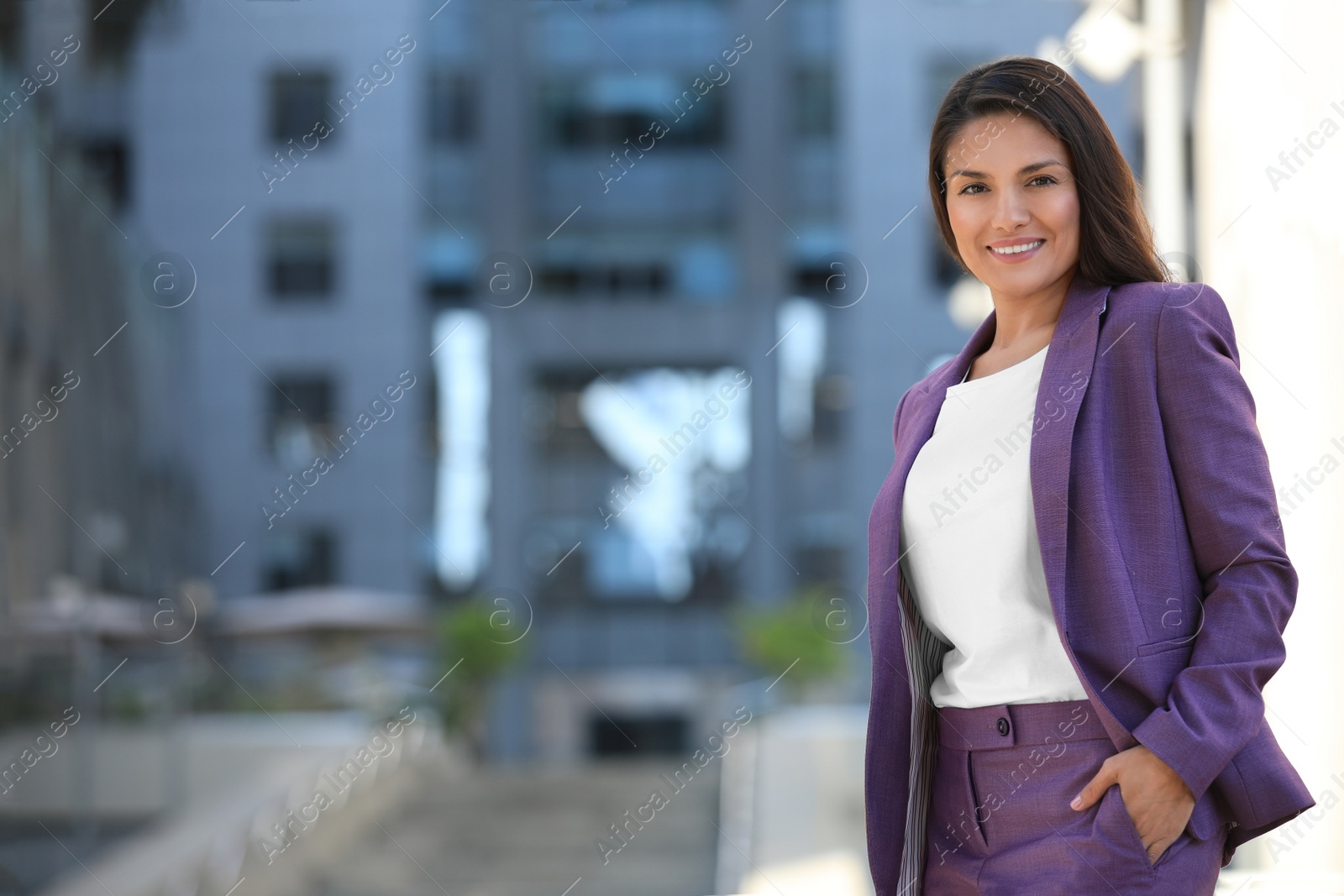 Photo of Beautiful confident businesswoman on city street. Space for text