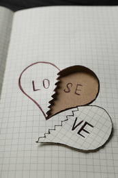 Photo of Broken heart with words LOVE and LOSE in notebook, closeup. Relationship problems concept