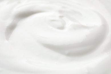 Delicious creamy yogurt as background, closeup view