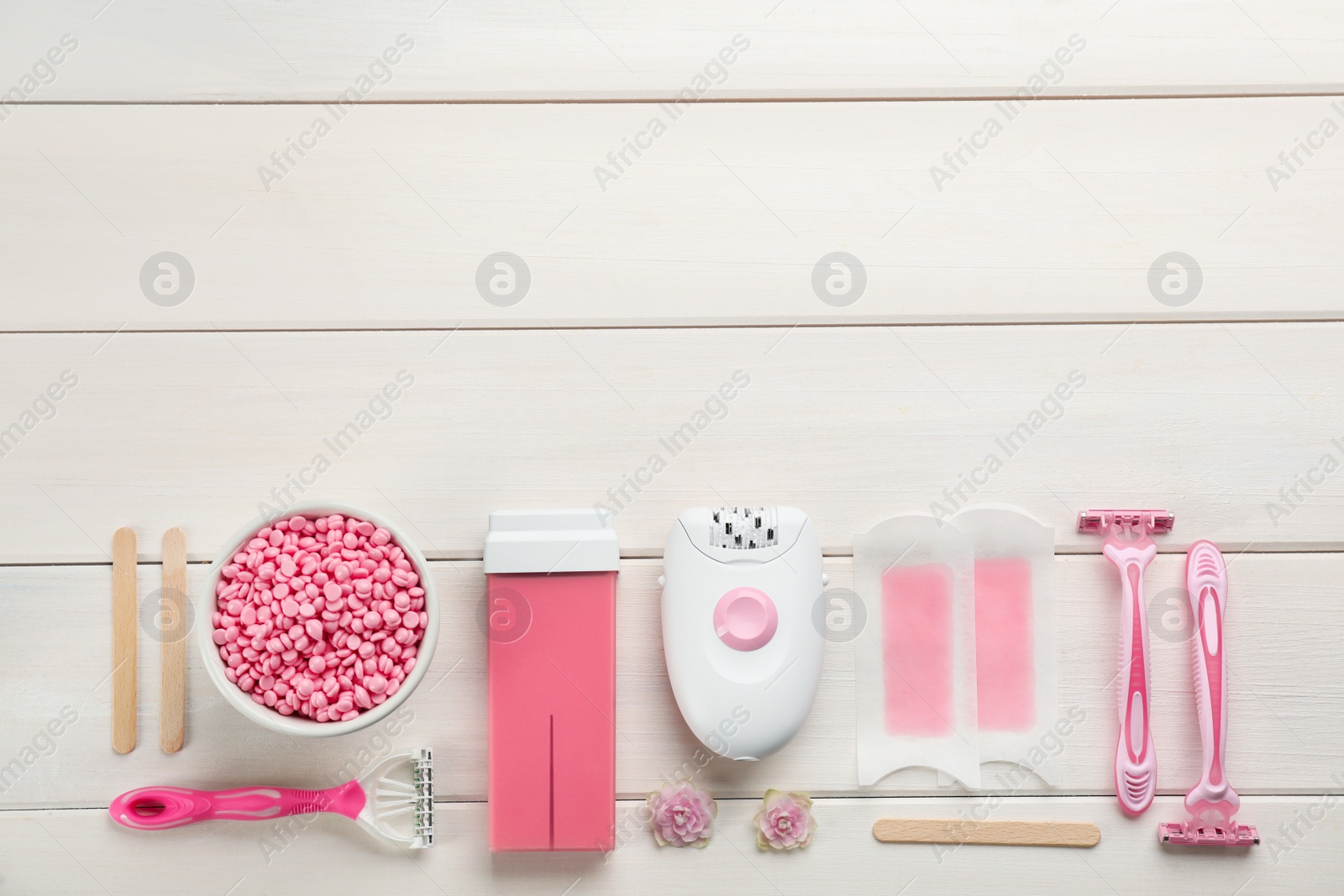 Photo of Set of epilation products on white wooden table, flat lay. Space for text