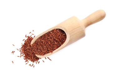 Photo of Wooden scoop with brown rice on white background, top view