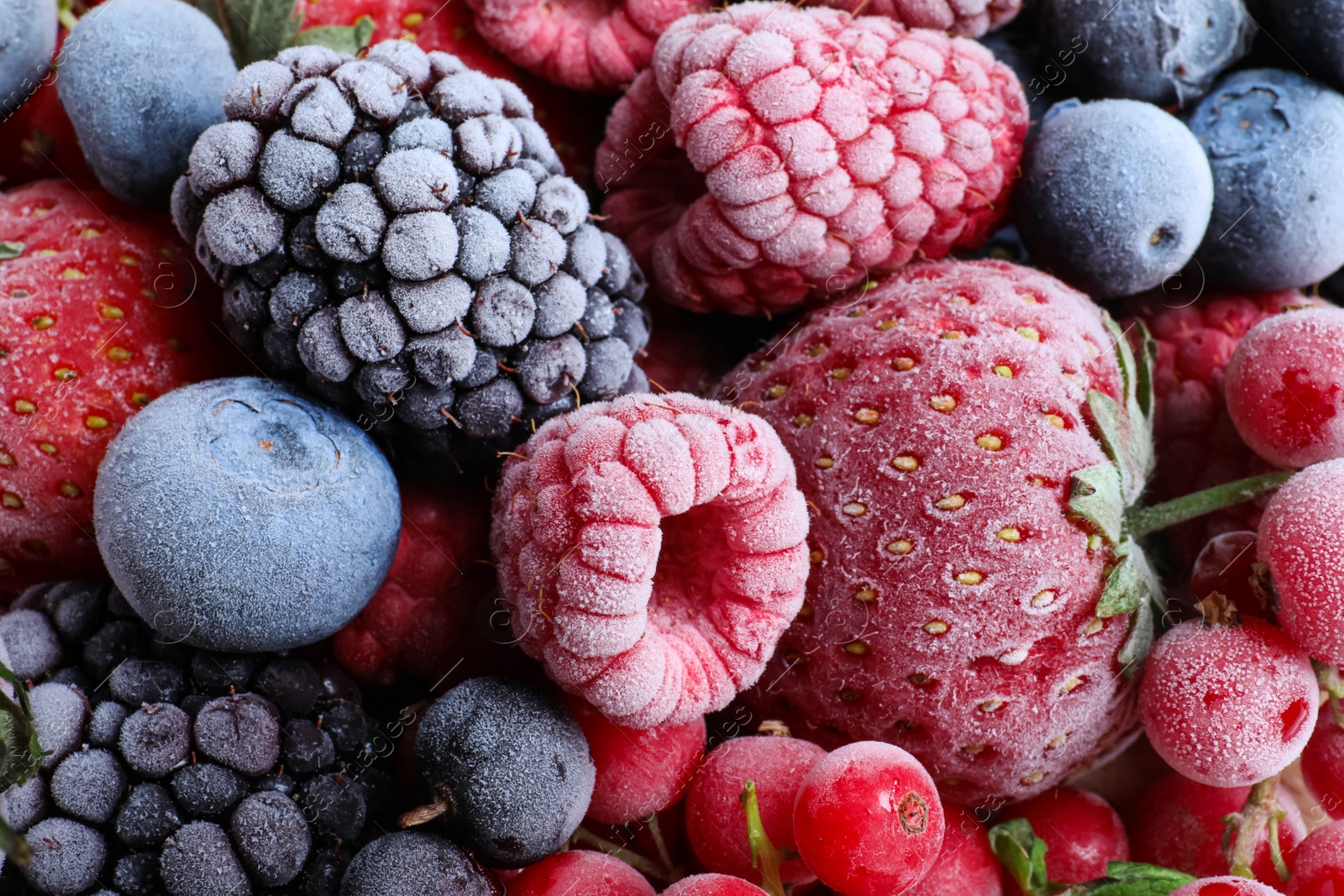 Photo of Mix of different frozen berries as background, top view