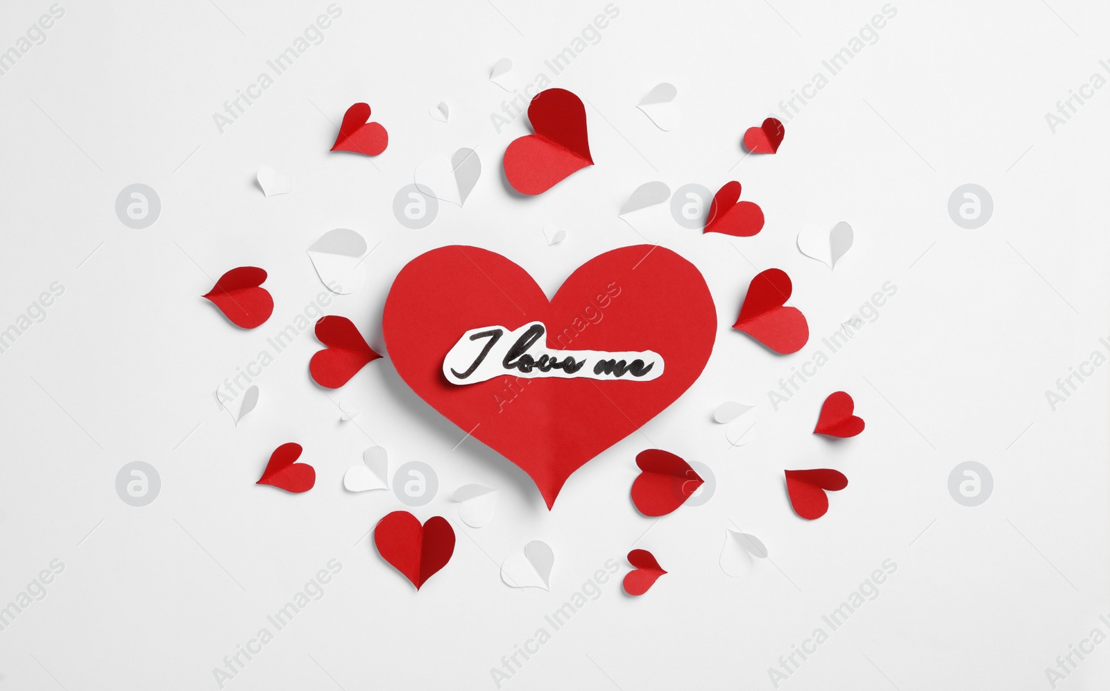 Photo of I Love Me. Many paper hearts on white background, top view