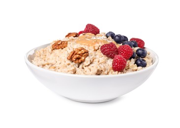 Photo of Tasty boiled oatmeal with berries, walnuts, peanut butter and chia seeds in bowl isolated on white