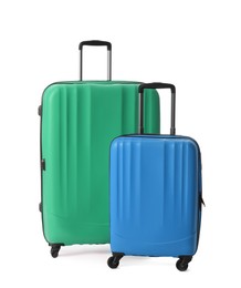 Stylish suitcases for travelling on white background