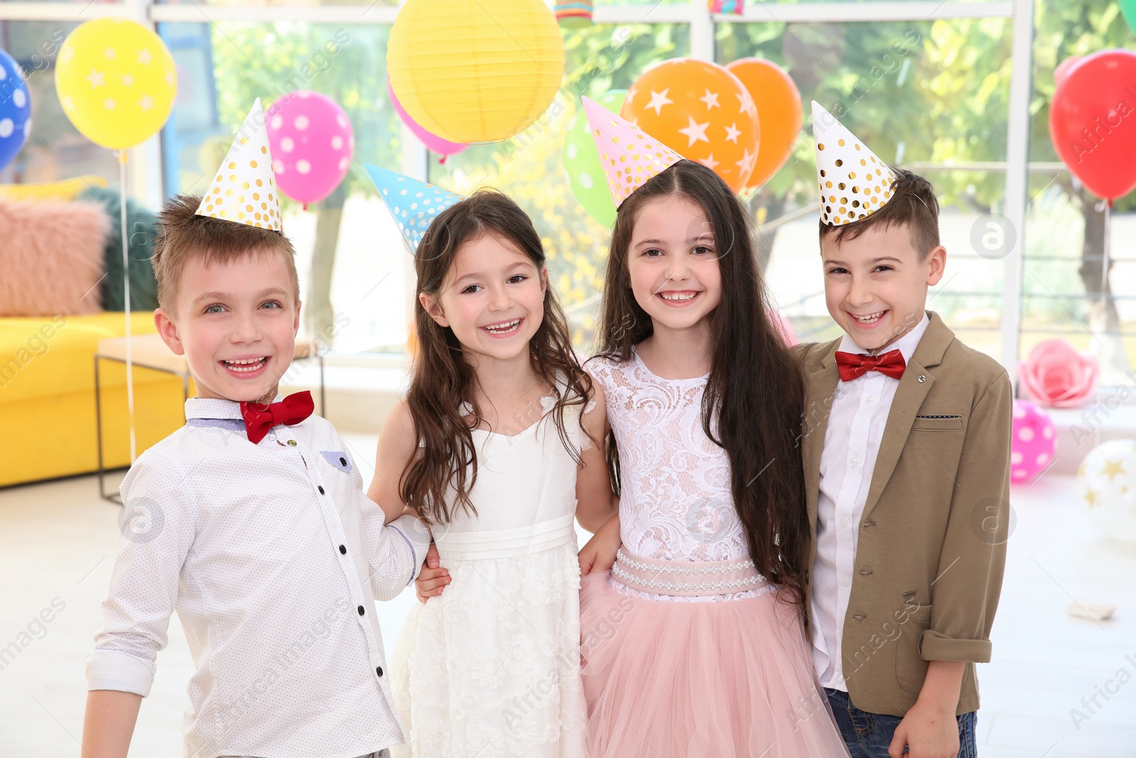 Photo of Cute little children at birthday party indoors