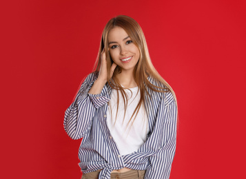 Teenage girl in casual outfit on red background