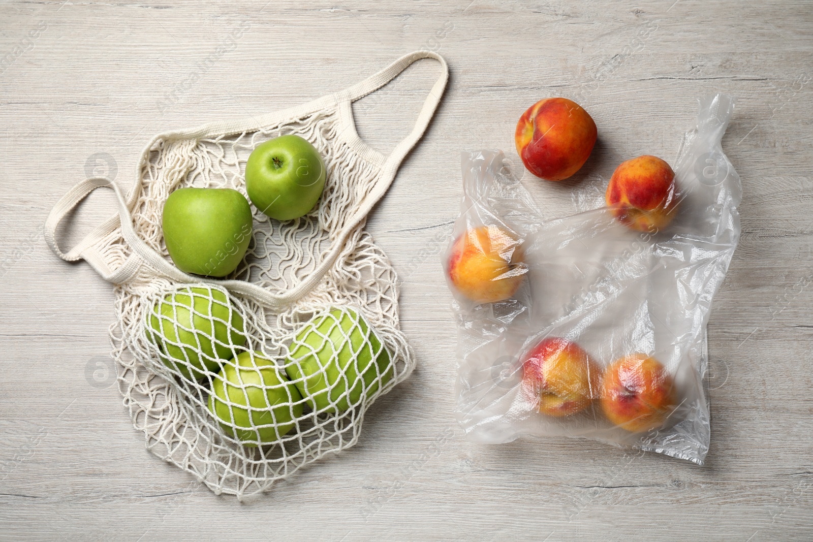 Photo of Fresh ripe apples and peaches on white wooden table, flat lay