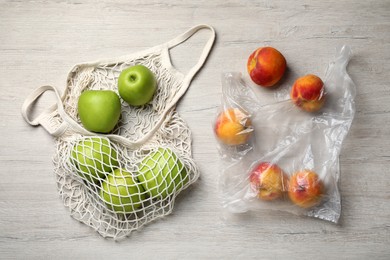 Fresh ripe apples and peaches on white wooden table, flat lay