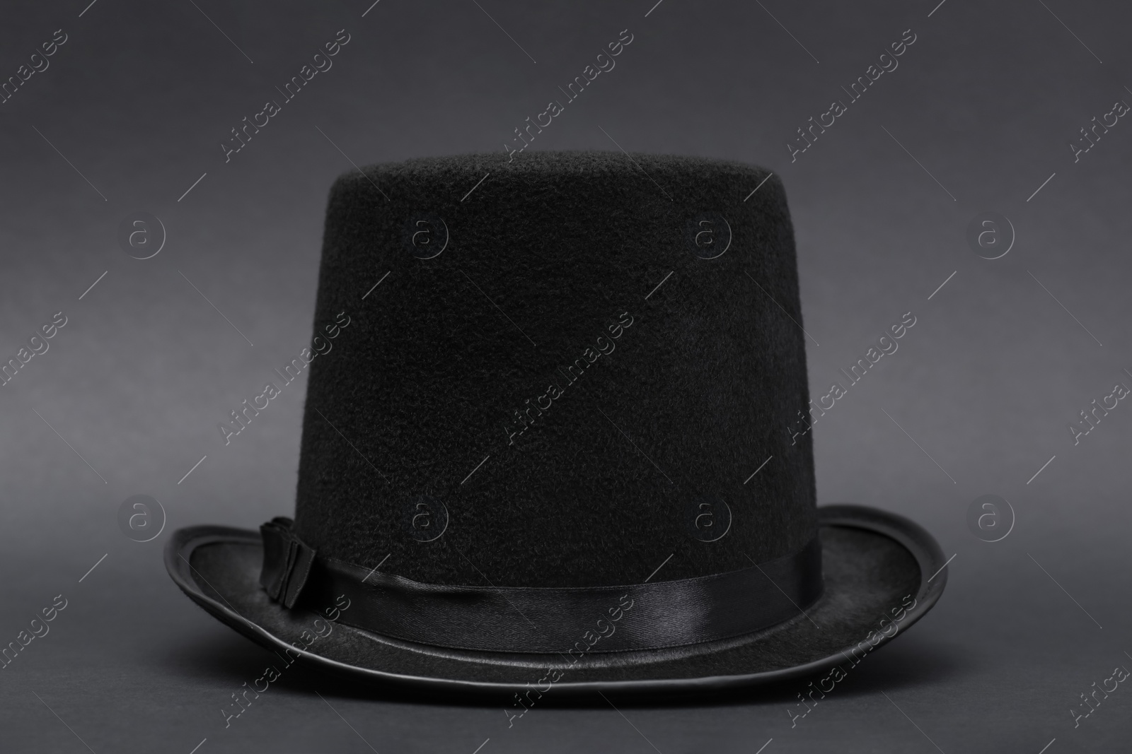 Photo of One magician top hat on dark grey background