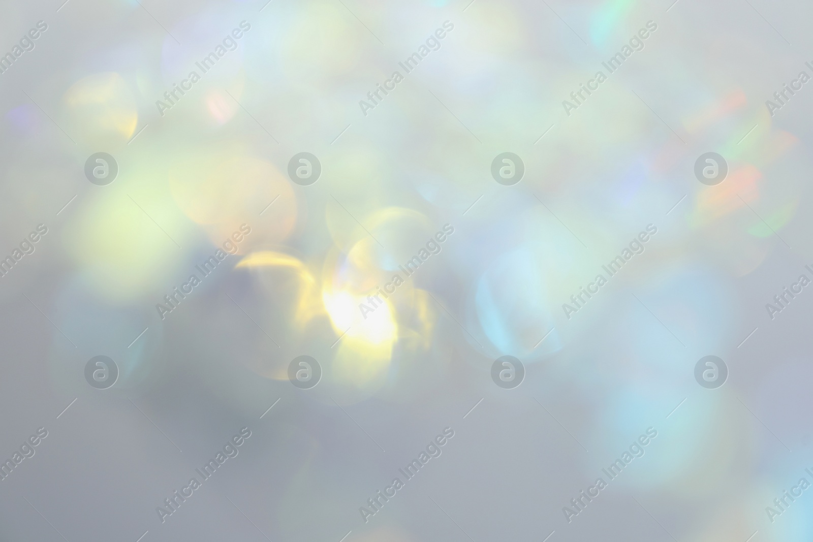 Photo of Blurred view of shiny lights on light background. Bokeh effect