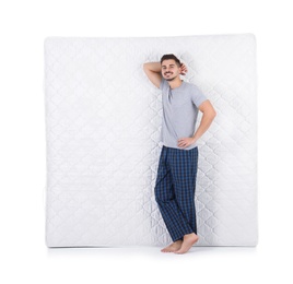 Young man with comfortable mattress isolated on white