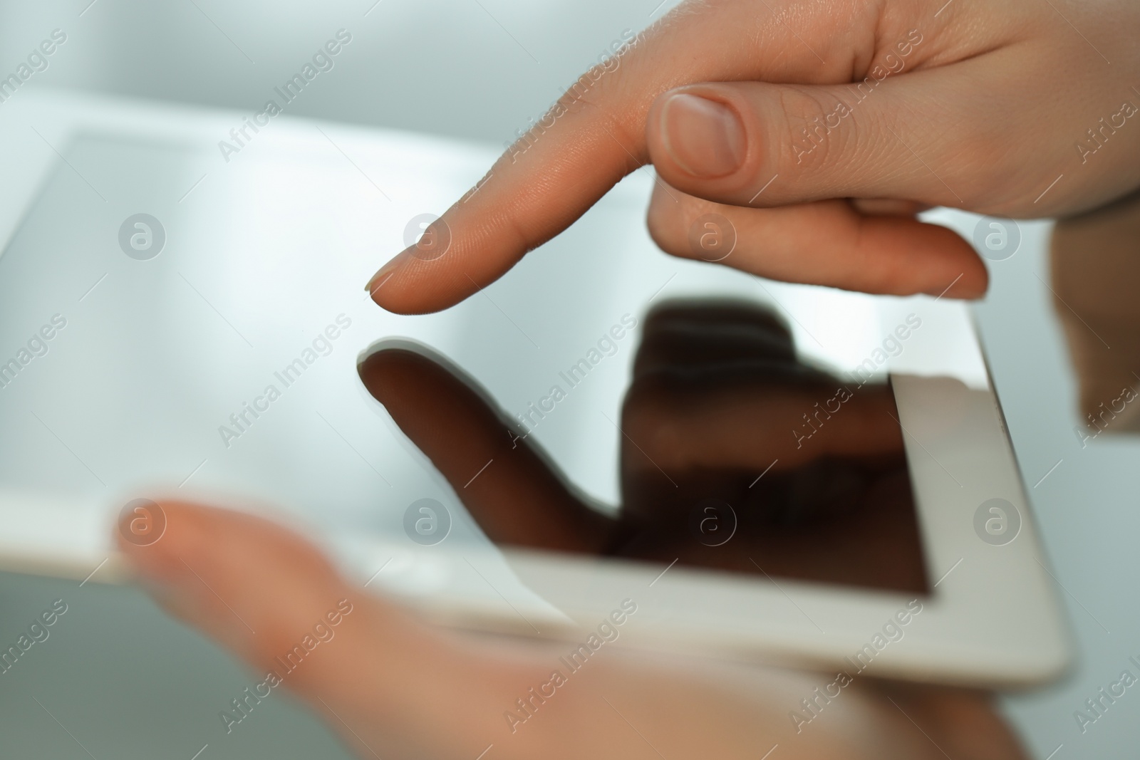 Photo of Closeup view of woman using modern tablet on blurred background