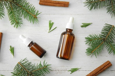 Flat lay composition with essential oils and ingredients on wooden background