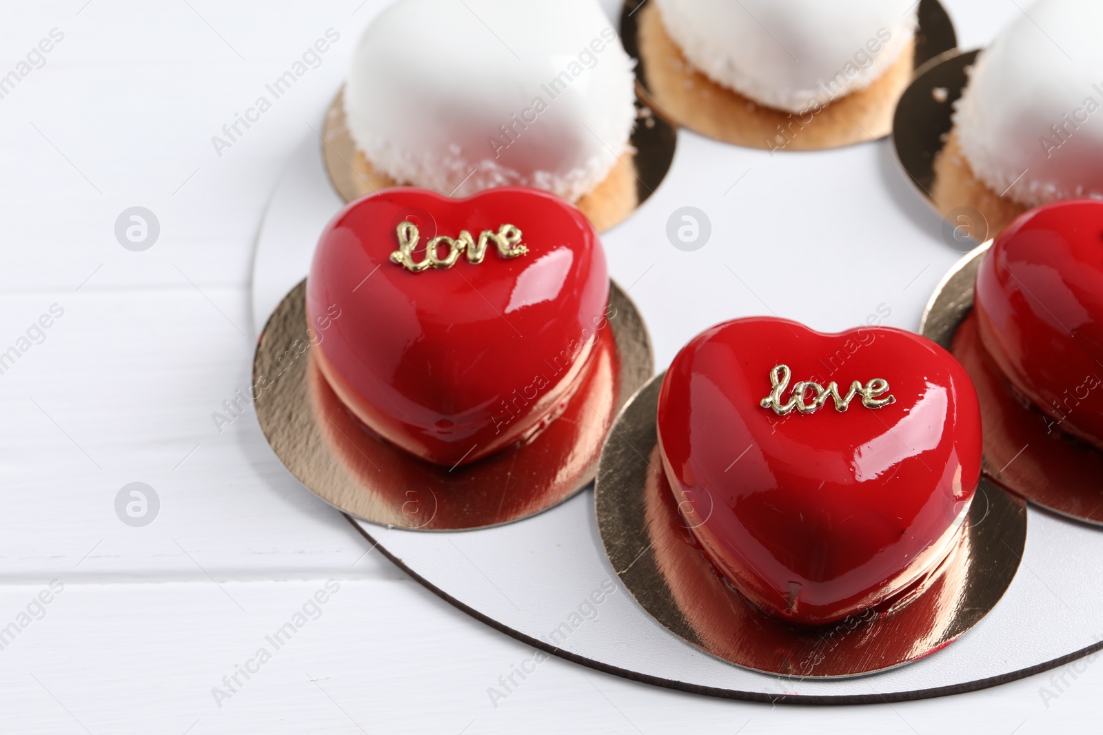 Photo of St. Valentine's Day. Delicious heart shaped cakes on white wooden table