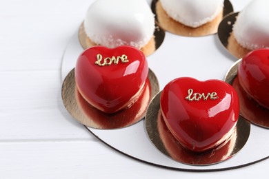 Photo of St. Valentine's Day. Delicious heart shaped cakes on white wooden table
