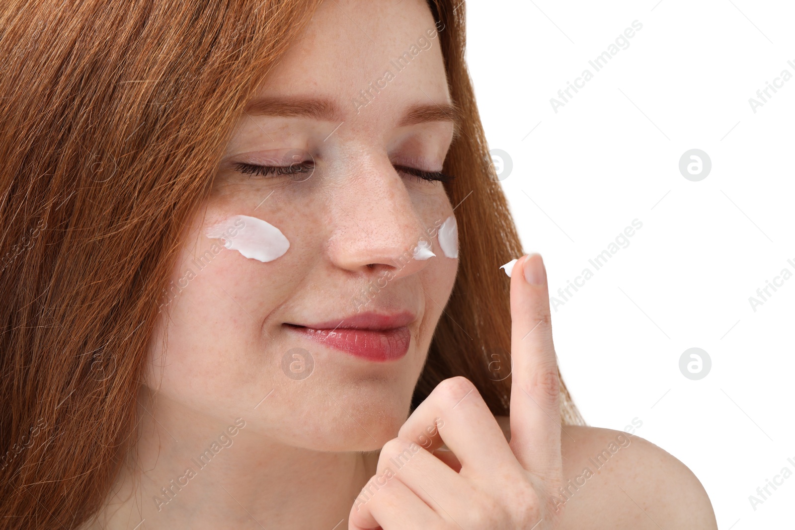 Photo of Beautiful woman with freckles and cream on her face against white background, closeup