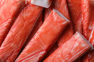 Fresh red crab sticks as background, closeup