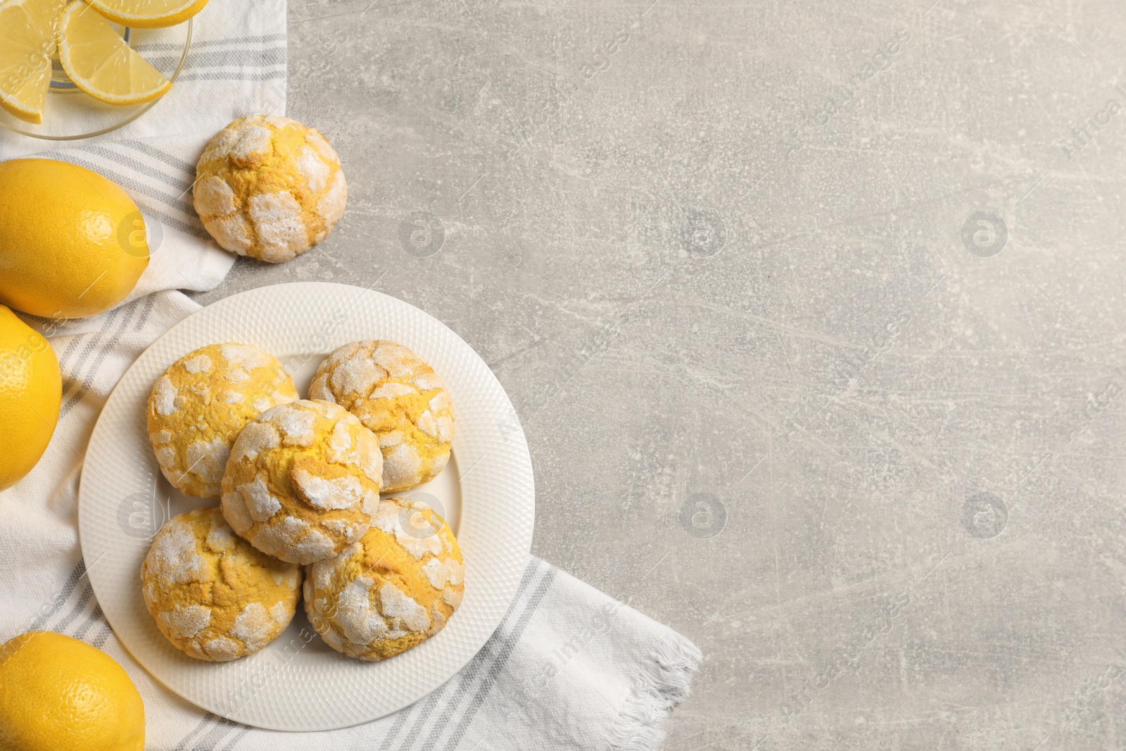 Photo of Flat lay composition with tasty lemon cookies on grey table. Space for text