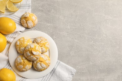 Photo of Flat lay composition with tasty lemon cookies on grey table. Space for text