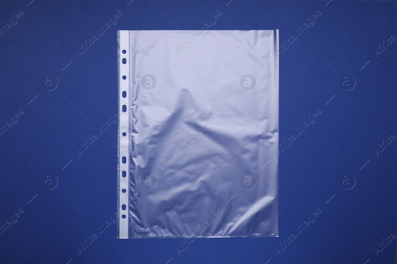 Photo of Punched pocket on blue background, top view