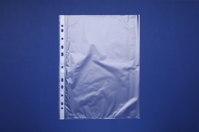 Photo of Punched pocket on blue background, top view