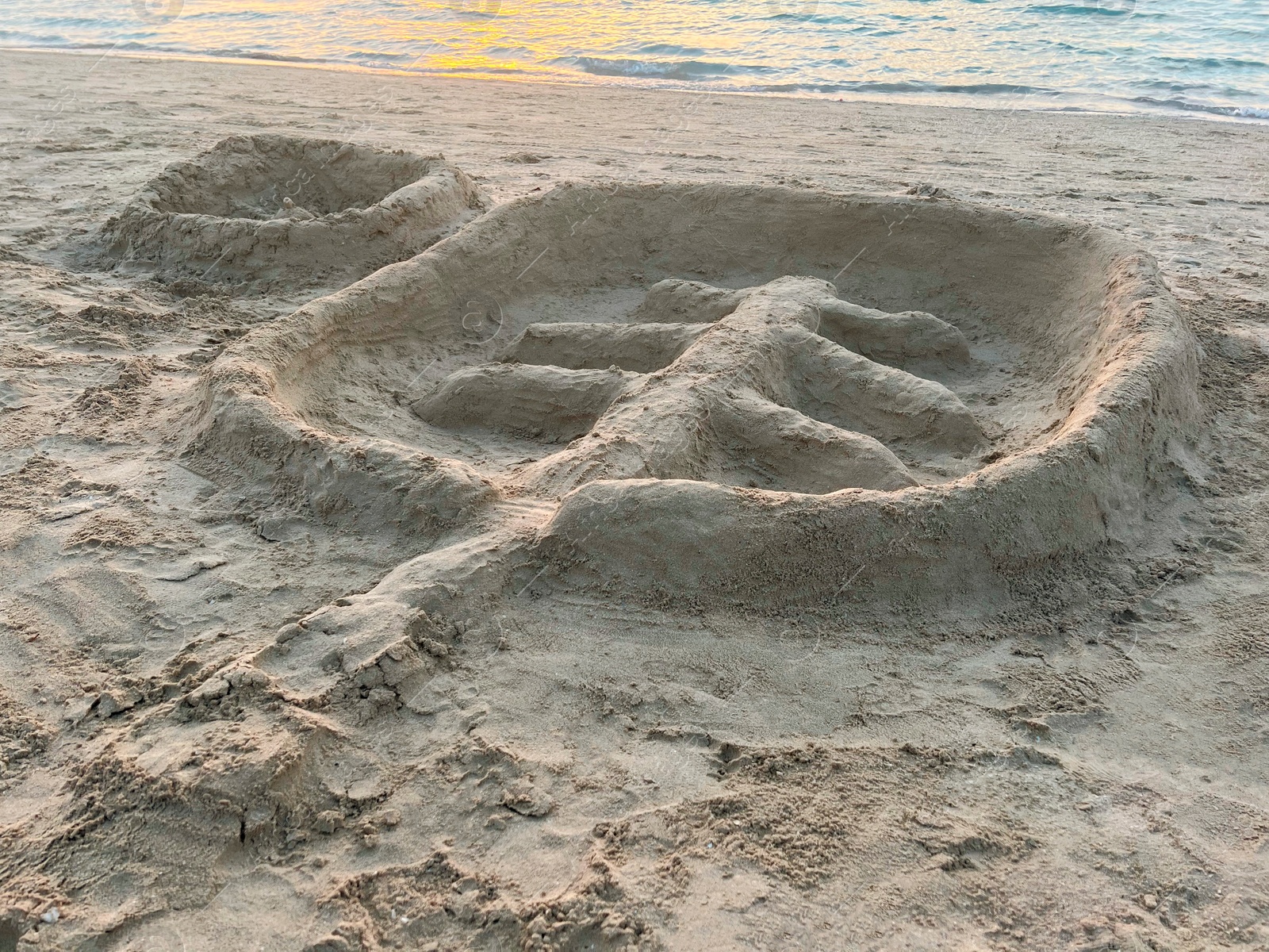 Photo of Palm tree made of sand on beach